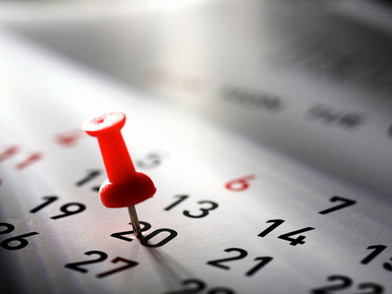 A calendar with a pin marking a scheduled date, symbolizing periodic polygraph testing in a warehousing environment.