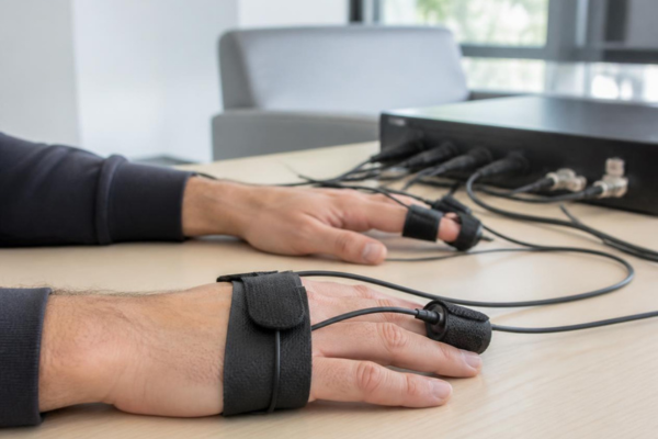 Hands connected to polygraph sensors during a professional examination